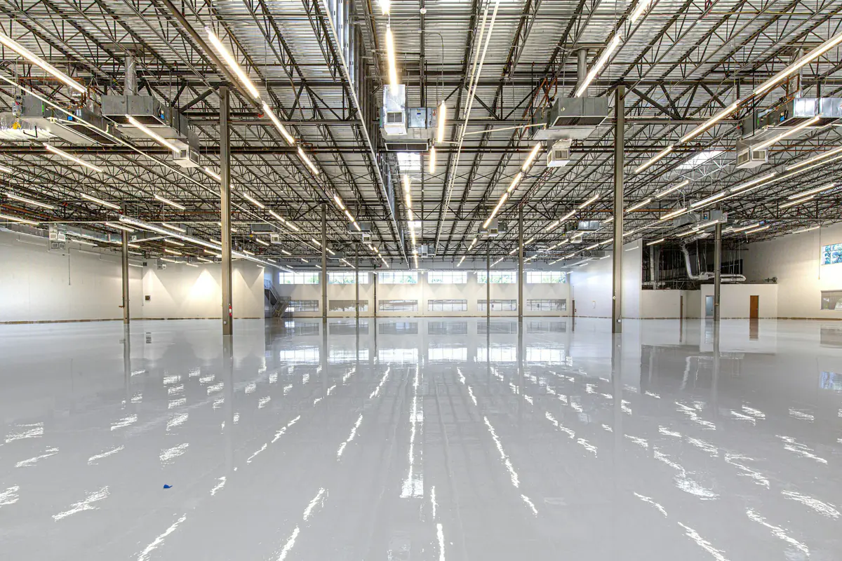 Bright warehouse floor reflecting overhead lighting